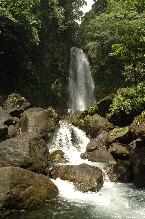 Photography. 540 waterfall milk water runs through black volcanic rocks