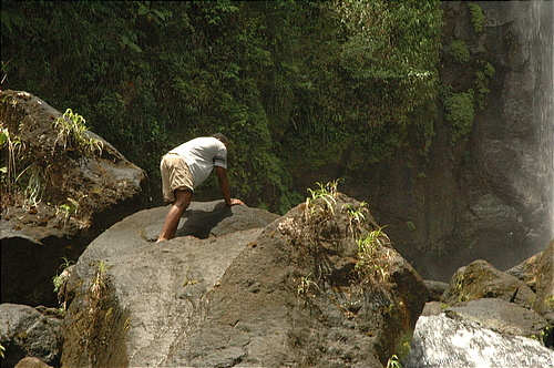 Photography. 550 caribbean man on huge volcanic rock